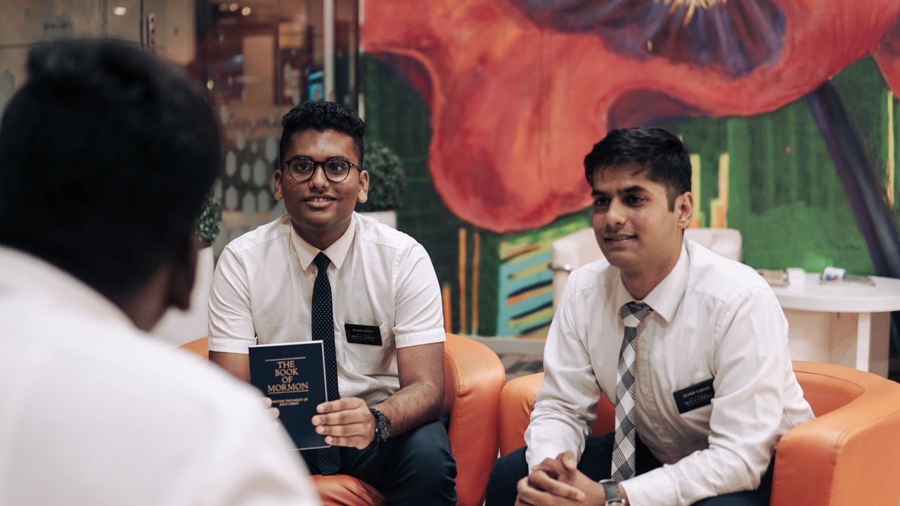 Missionaries teach a family in their home
