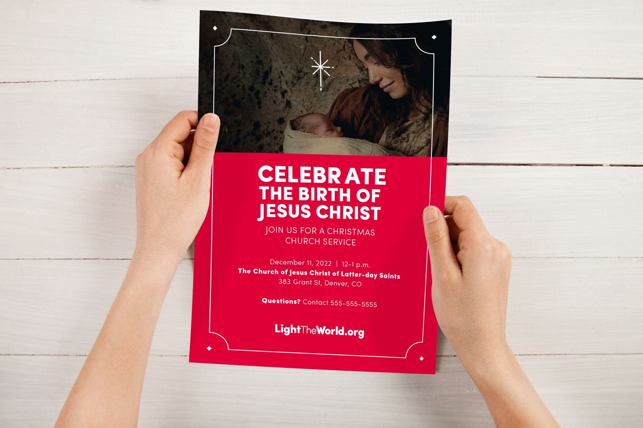Hands holding a Christmas service invitation